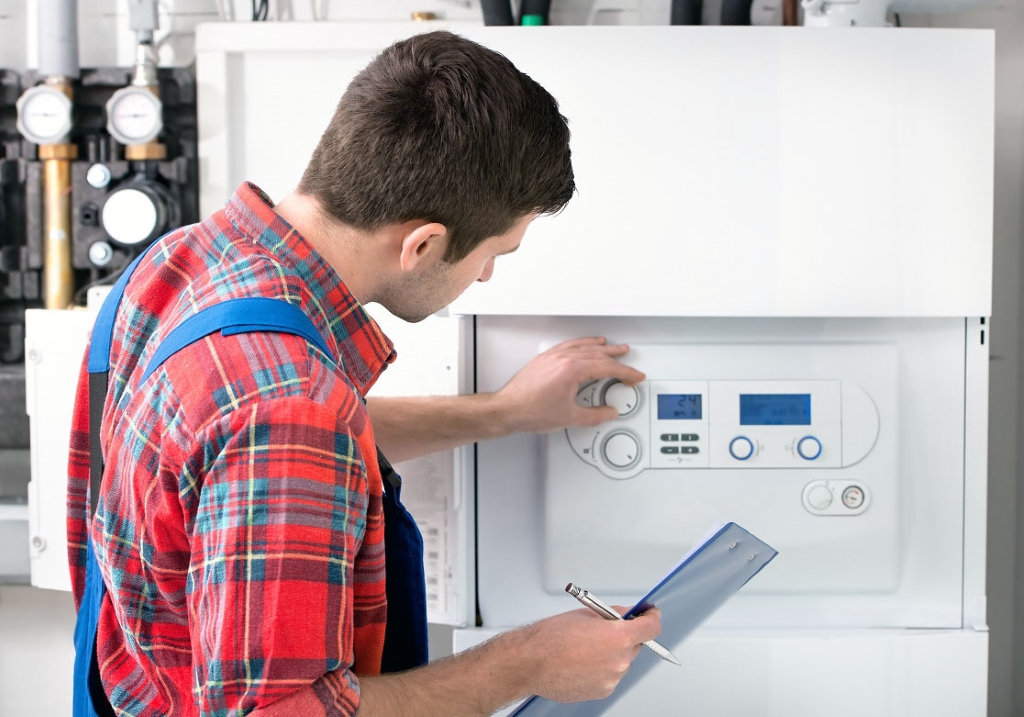 Technician servicing the gas boiler for hot water and heating